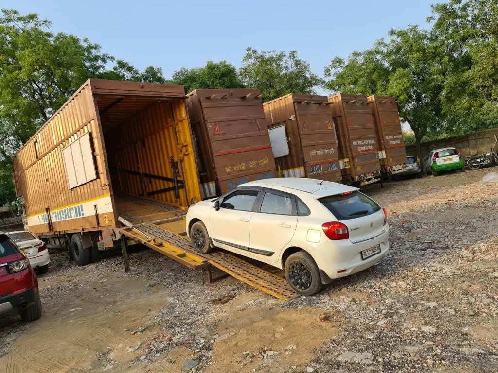 Hariom Packers and Movers car transportation service with secure vehicle carrier loading